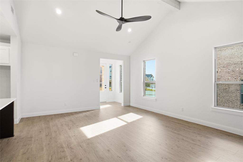 218 Legacy Boulevard Weatherford, TX 76086 - Photo 7 of 20 an empty room with wooden floor fan and windows