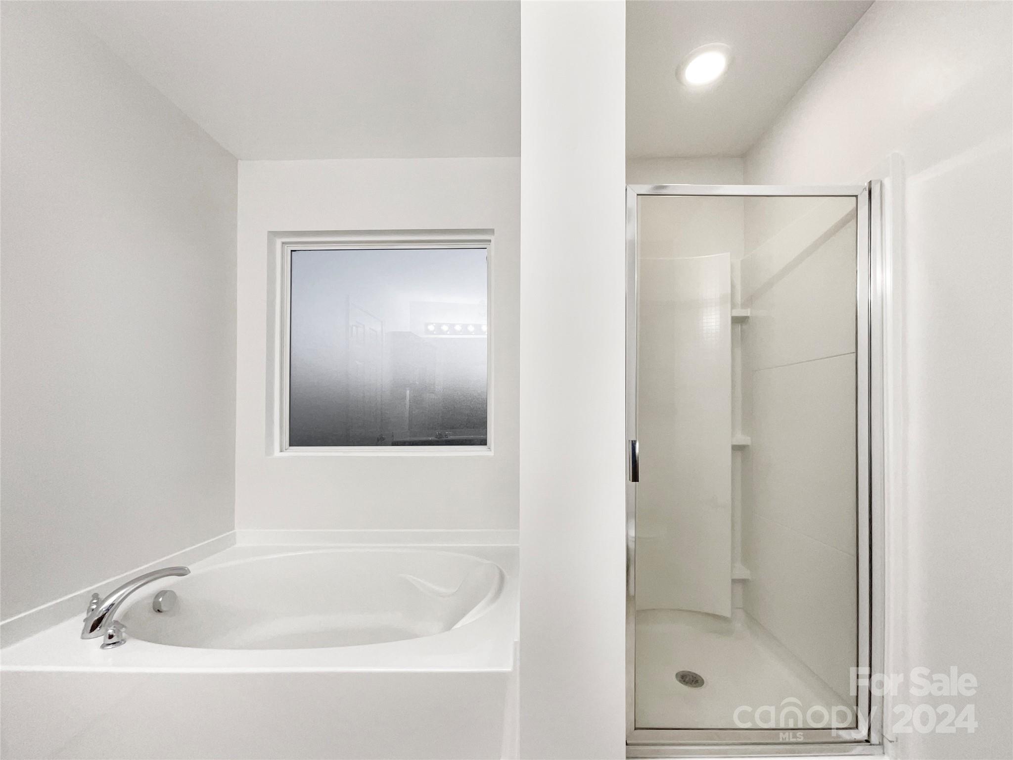 1005 Garden Web Road Indian Trail, NC 28079 - Photo 23 of 25 a white bath tub sitting next to a shower