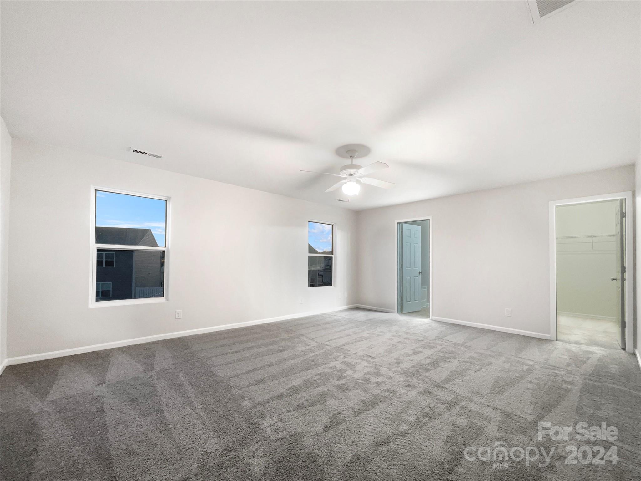 1005 Garden Web Road Indian Trail, NC 28079 - Photo 5 of 25 a view of an empty room with window and chandelier fan