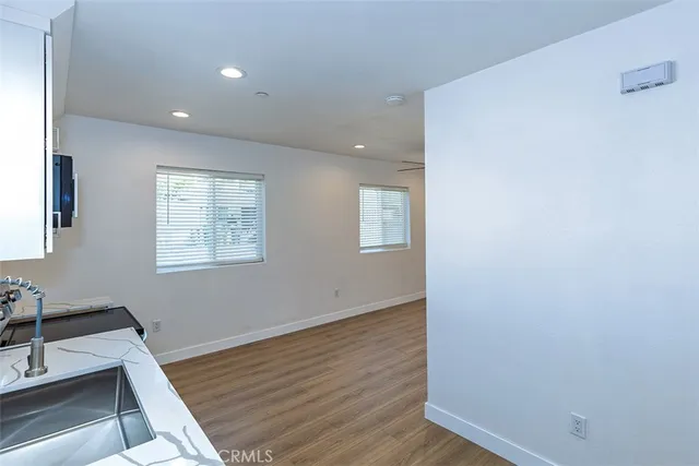 a view of a room with wooden floor and window