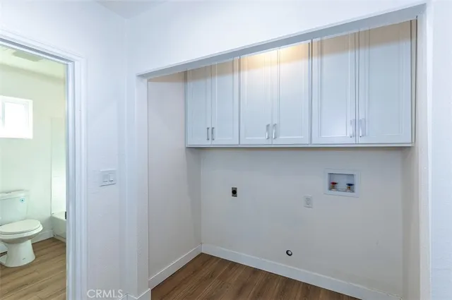 a kitchen with granite countertop white cabinets and stainless steel appliances