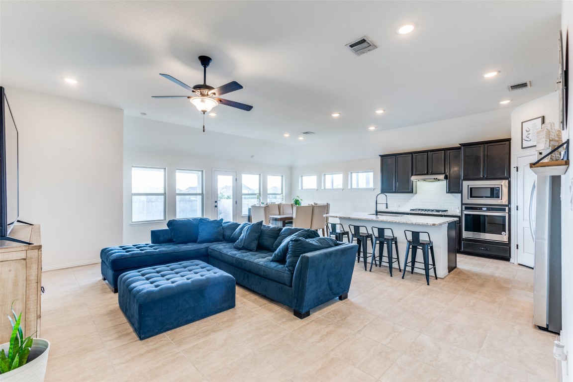 874 Spinnaker Loop Kyle, TX 78640 - Photo 5 of 30 Living room with ceiling fan and recessed lighting