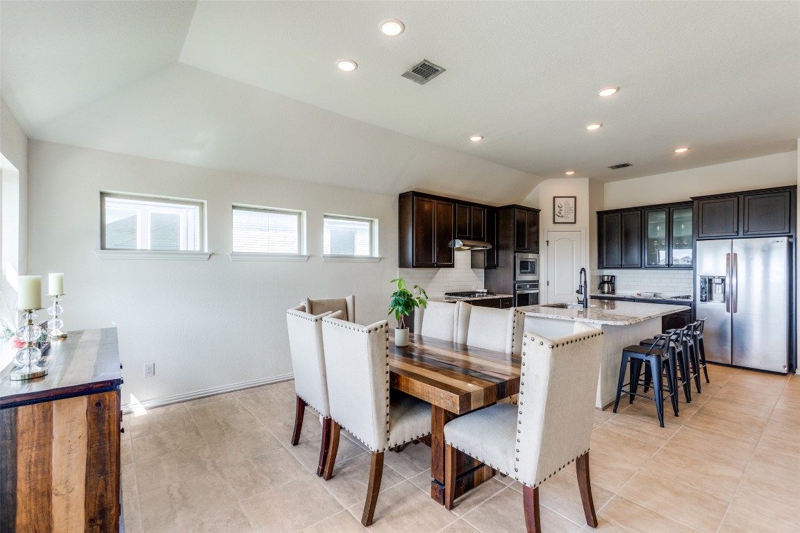 874 Spinnaker Loop Kyle, TX 78640 - Photo 10 of 30 Dining room featuring vaulted ceiling and recessed lighting