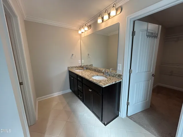 a white toilet sitting next to a white cabinet