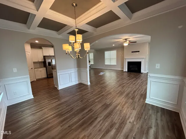 a view of a room with wooden floors and fireplace