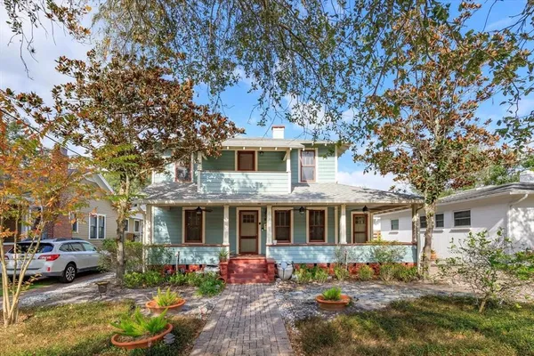 a front view of a house with a yard and a porch