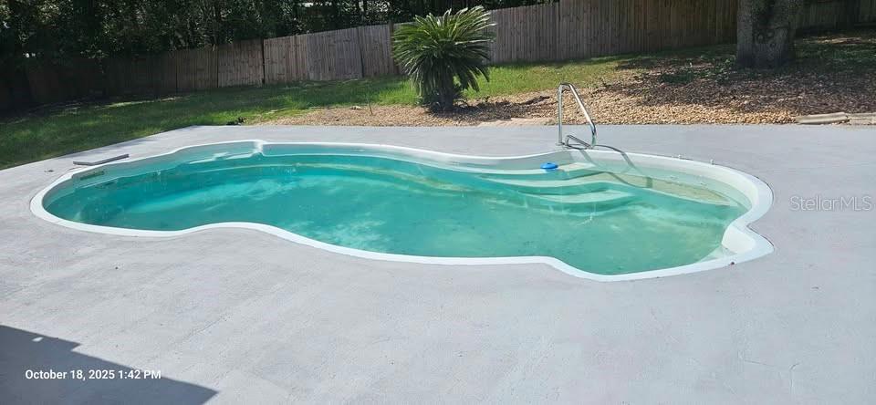17200 Southeast 97th Terrace Summerfield, FL 34491 - Photo 13 of 14 a swimming pool with some trees in the background
