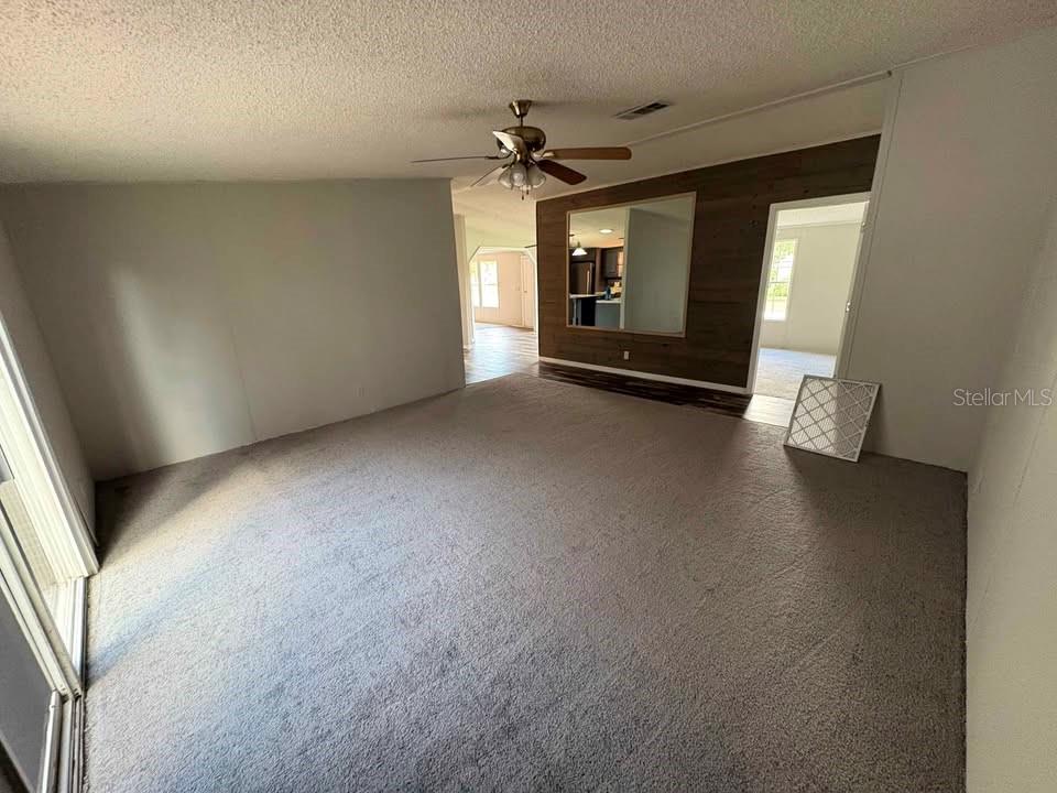 17200 Southeast 97th Terrace Summerfield, FL 34491 - Photo 8 of 14 an empty room with a fireplace and windows