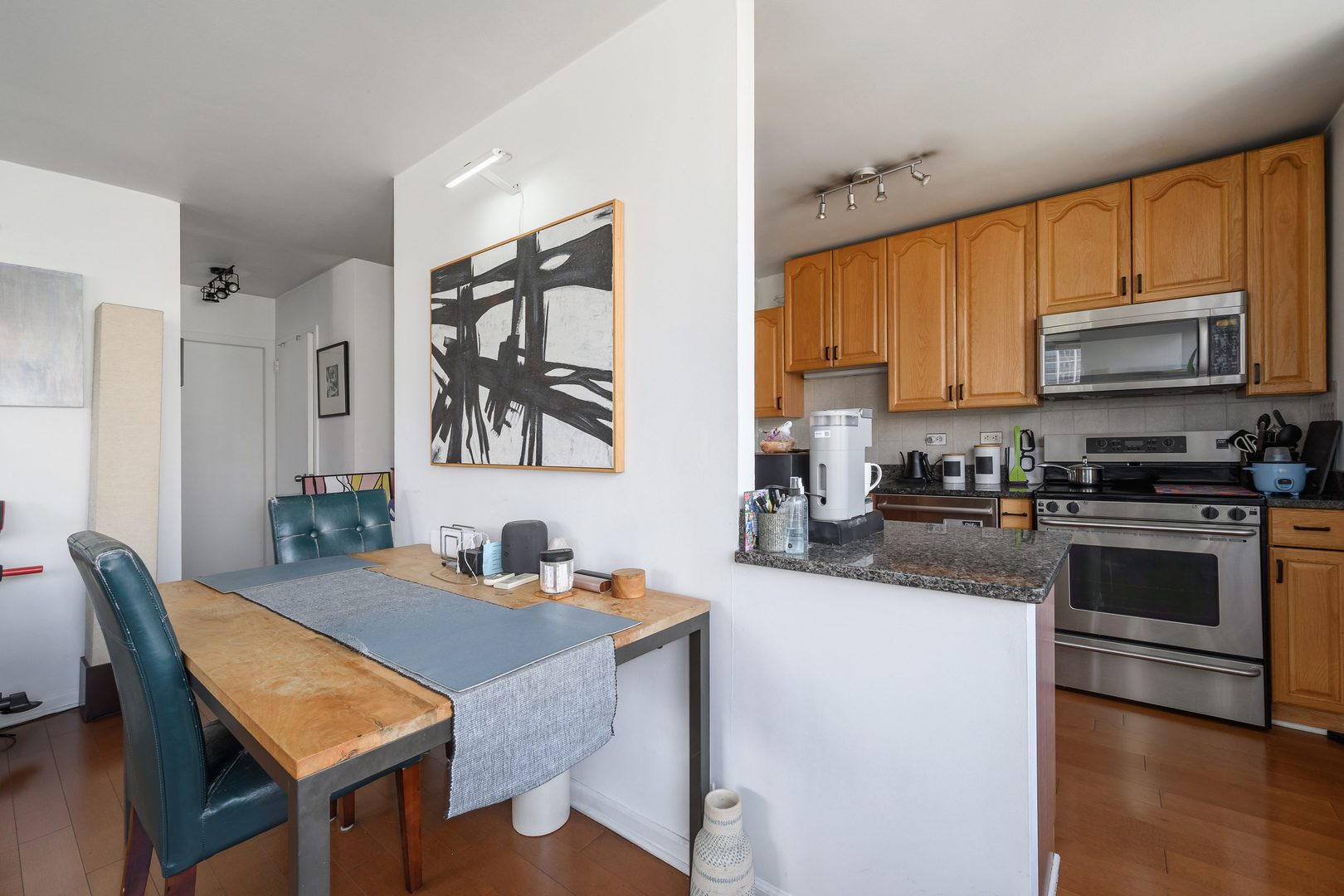 70 West Burton Place, Unit 705 Chicago, IL 60610 - Photo 8 of 17 a kitchen with stainless steel appliances a stove a sink a microwave a refrigerator and cabinets