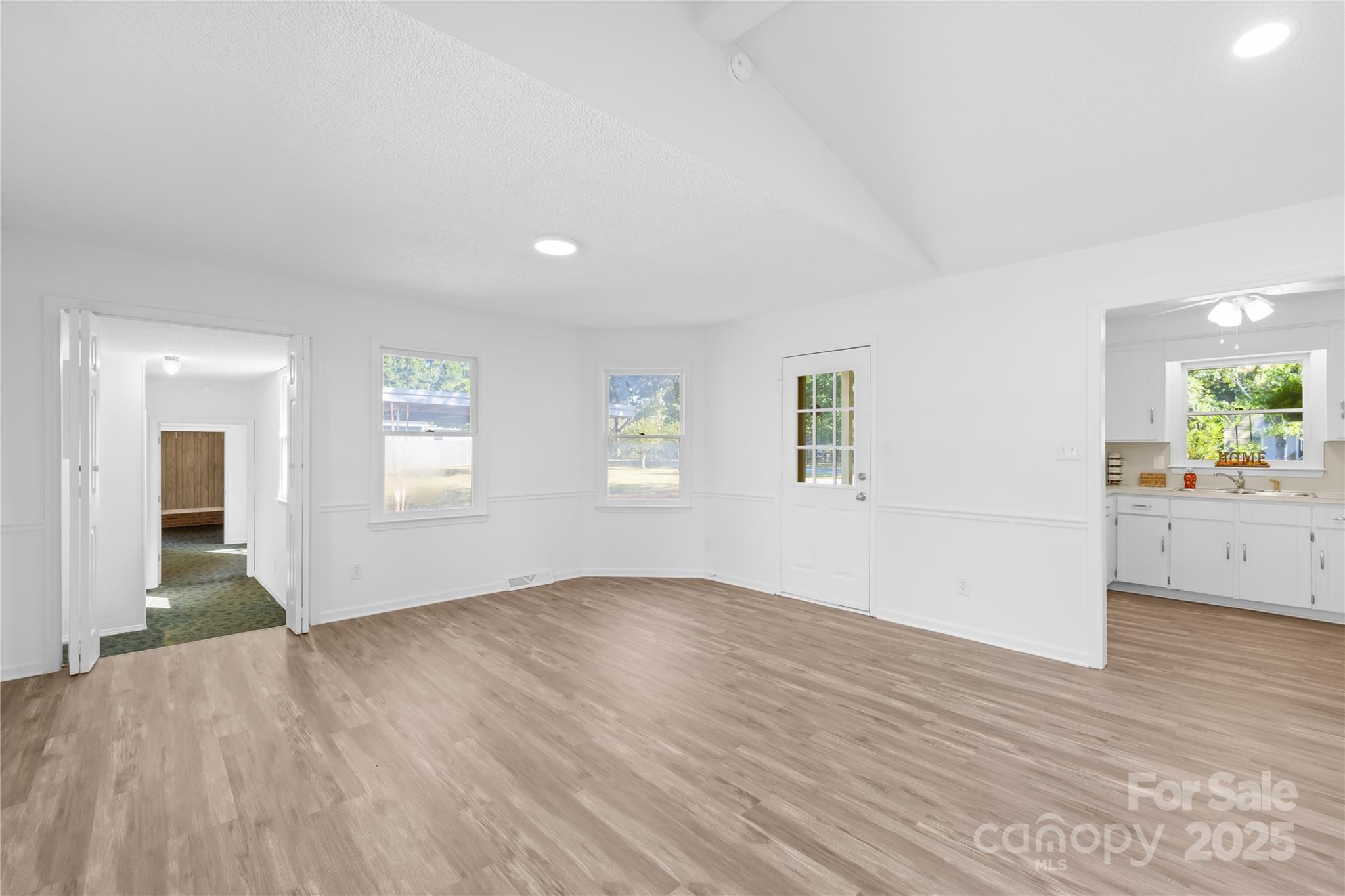 700 Chestnut Lane Matthews, NC 28104 - Photo 16 of 39 an empty room with wooden floor and windows
