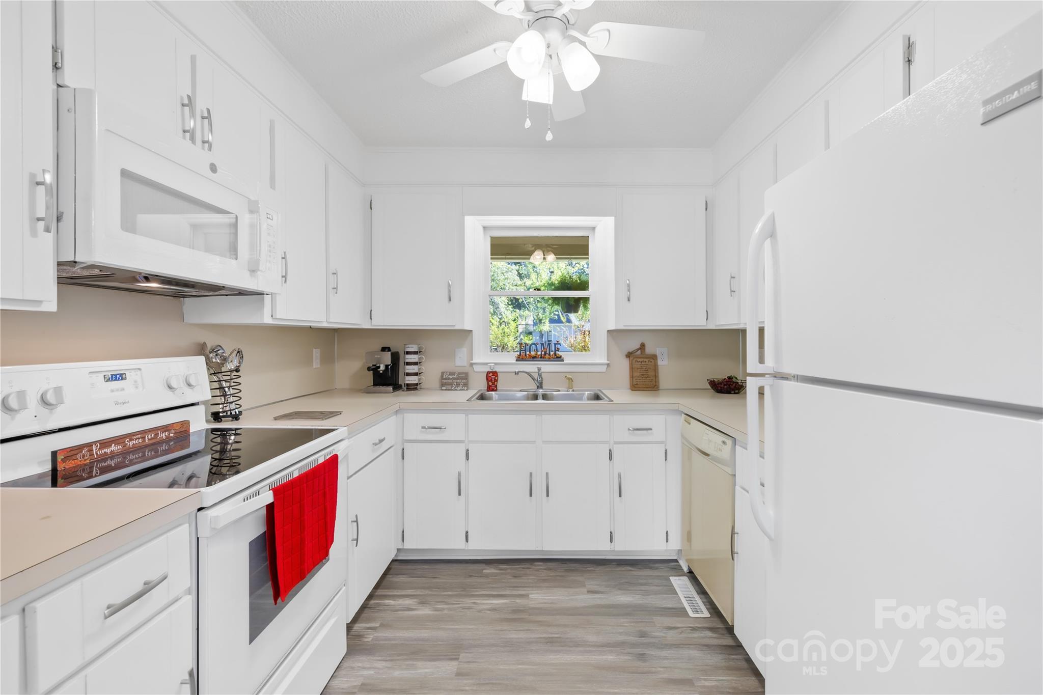 700 Chestnut Lane Matthews, NC 28104 - Photo 17 of 39 a kitchen with a white cabinets and white appliances