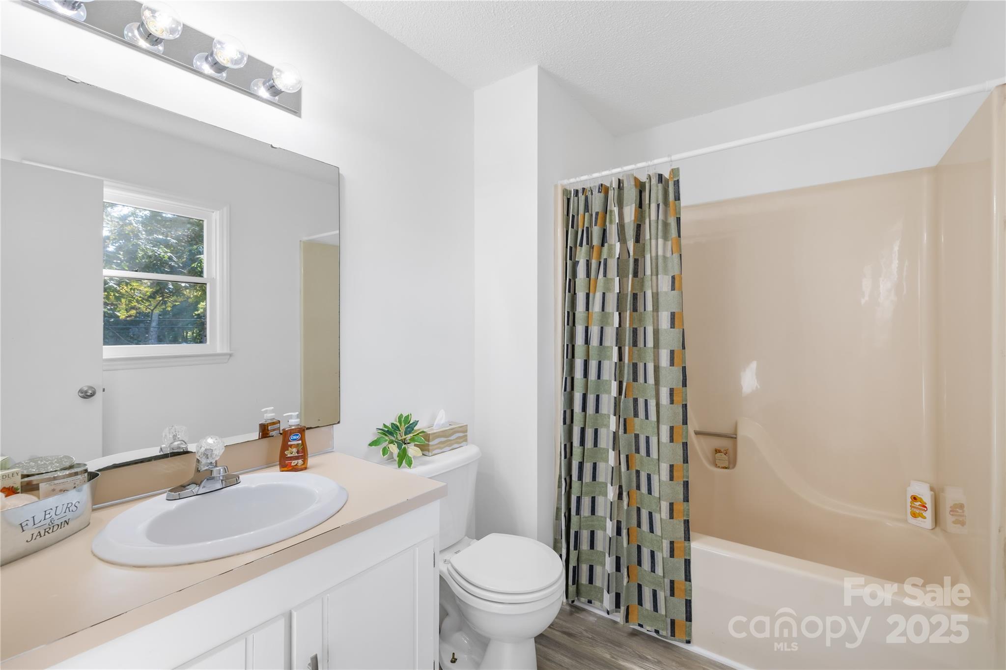 700 Chestnut Lane Matthews, NC 28104 - Photo 22 of 39 a bathroom with a sink a toilet and shower