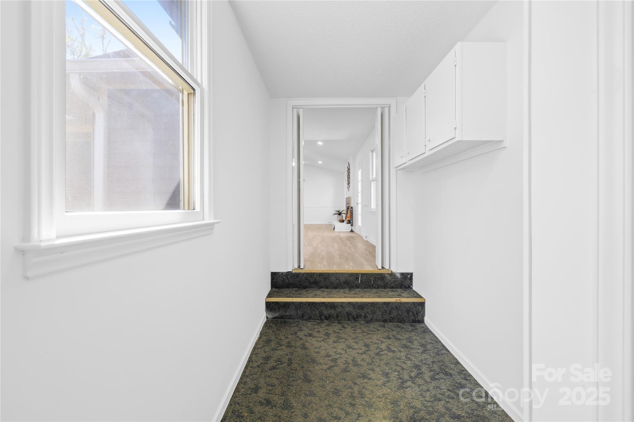 700 Chestnut Lane Matthews, NC 28104 - Photo 27 of 39 a view of a hallway with wooden floor and a bathroom