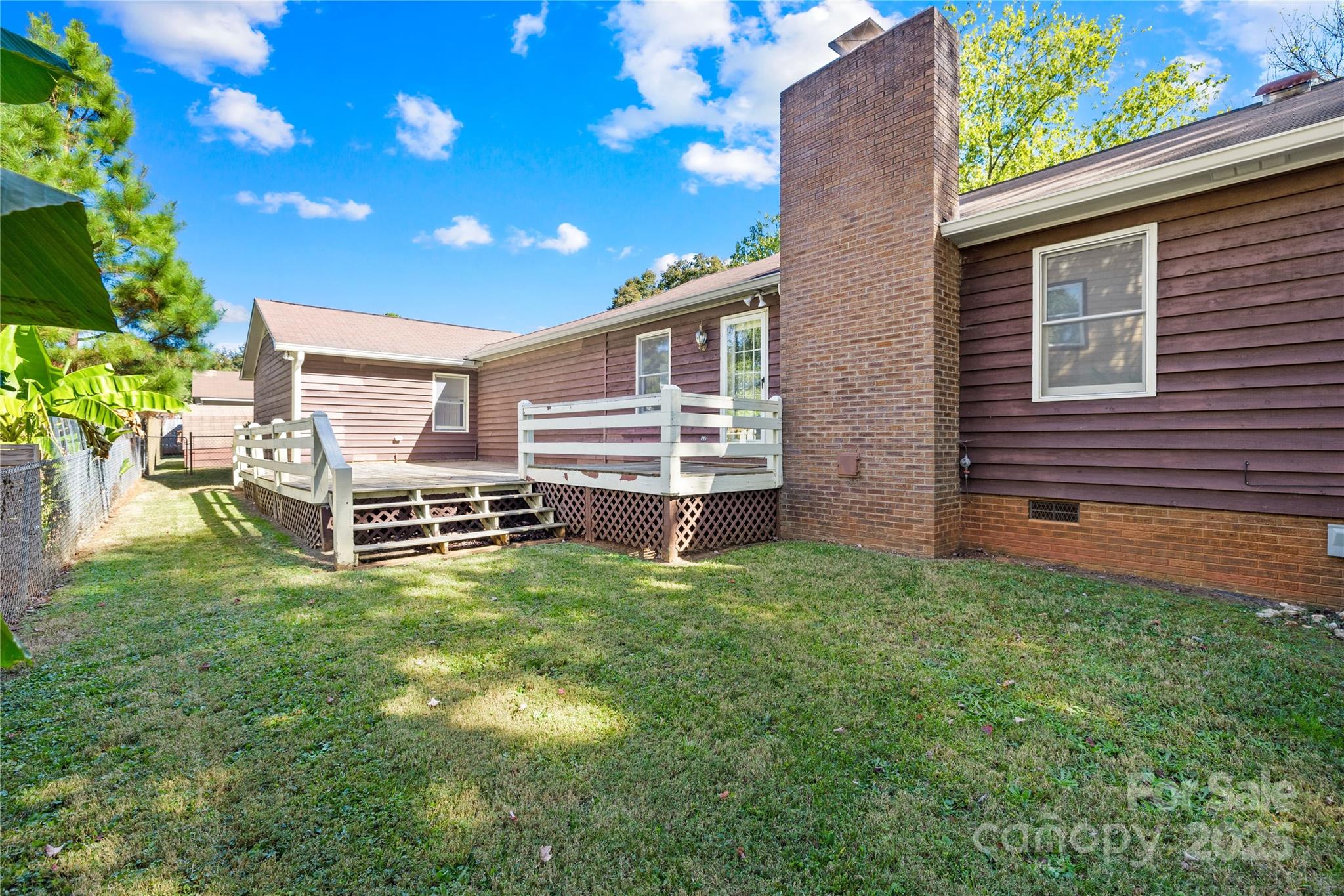 700 Chestnut Lane Matthews, NC 28104 - Photo 30 of 39 a backyard of a house with table and chairs