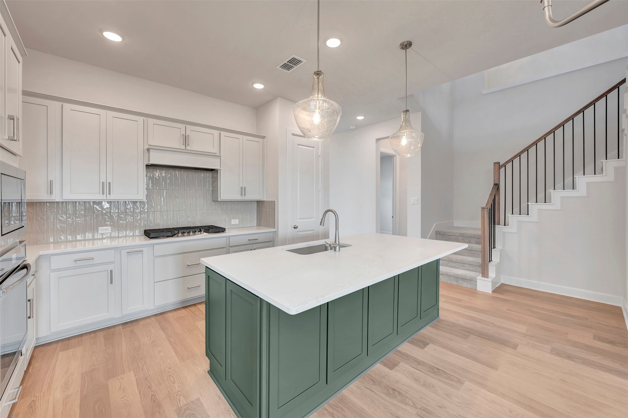 2718 Cottage Place Rosharon, TX 77583 - Photo 22 of 50 a kitchen with a sink cabinets and wooden floor