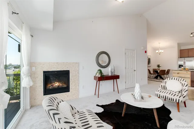 a living room with furniture a fireplace and a table