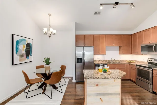 a kitchen with cabinets and stainless steel appliances