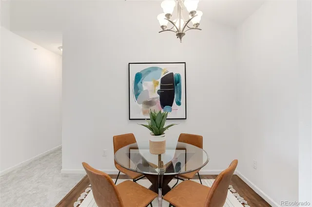 a dining room with furniture and wooden floor