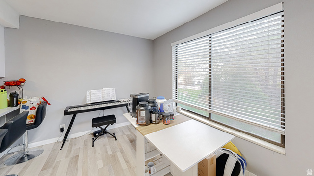 630 1100 West Provo, UT 84601 - Photo 17 of 64 Interior space featuring light gray walls, wood-finish flooring, and a large window with horizontal blinds