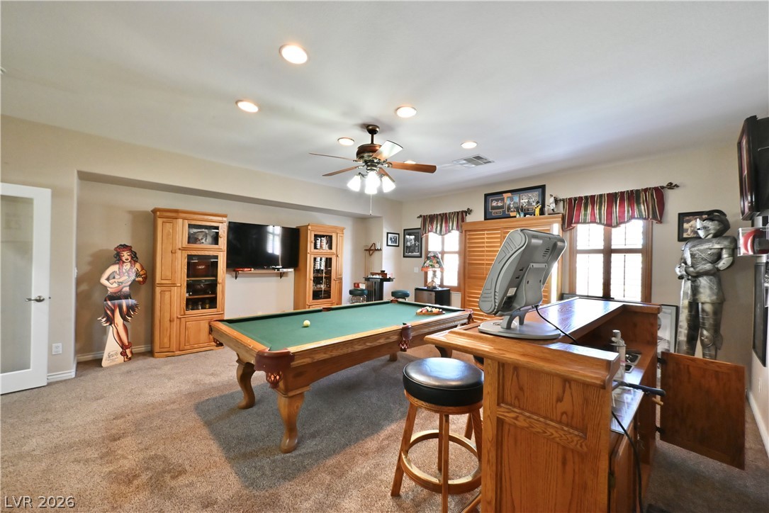 2729 Kildrummie Street Henderson, NV 89044 - Photo 27 of 42 A well-lit recreational room, featuring recessed lighting and a classic wooden wet bar, is perfect for entertaining.