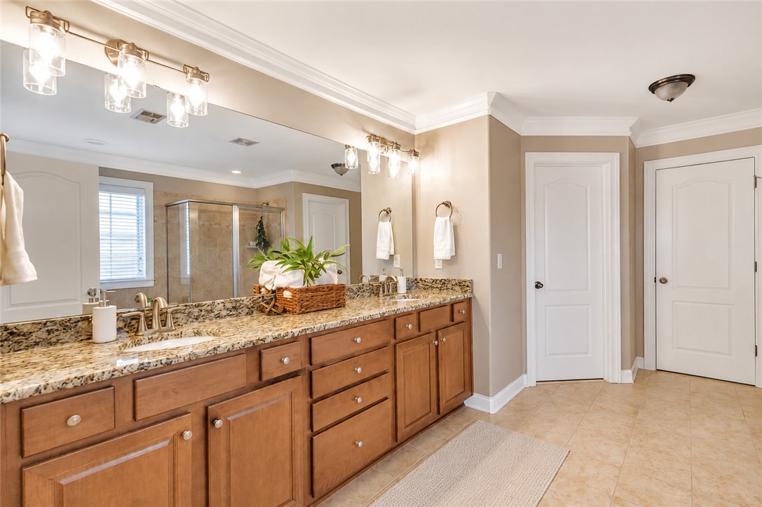 15 Fawn Hill Drive Anderson, SC 29621 - Photo 24 of 38 This spacious bathroom offers dual vanities with ample storage and a glass-enclosed shower.