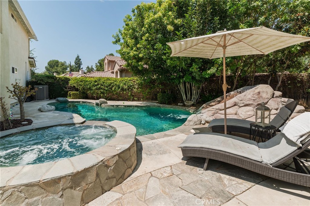 789 Glenhart Place Fallbrook, CA 92028 - Photo 20 of 40 a view of a patio with table and chairs under an umbrella