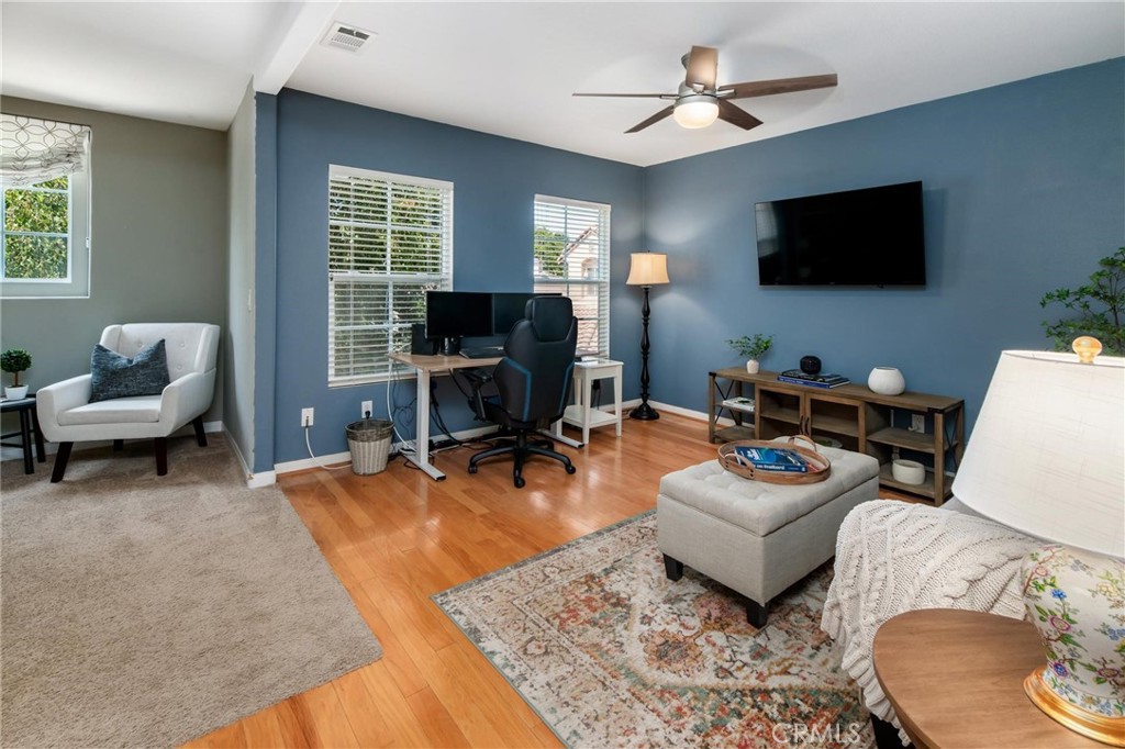 789 Glenhart Place Fallbrook, CA 92028 - Photo 23 of 40 a living room with furniture a flat screen tv and a window
