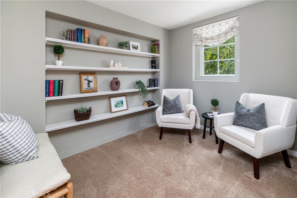 789 Glenhart Place Fallbrook, CA 92028 - Photo 24 of 40 a living room with furniture and a book shelf