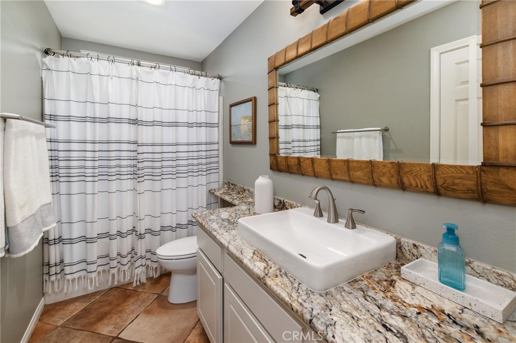 789 Glenhart Place Fallbrook, CA 92028 - Photo 29 of 40 a bathroom with a sink toilet and shower