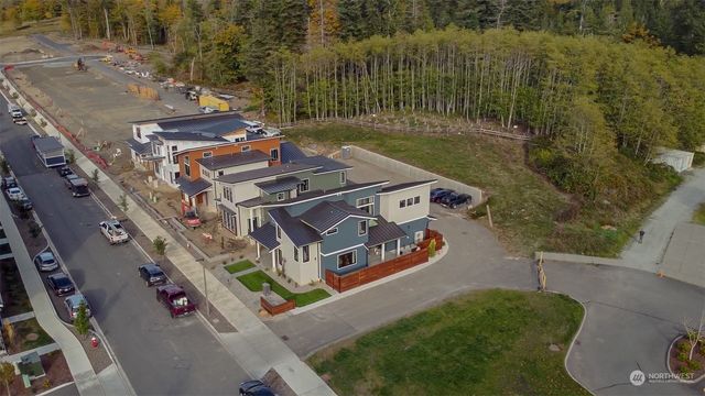 an aerial view of residential houses with outdoor space and street view