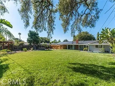 a front view of house with yard and trees