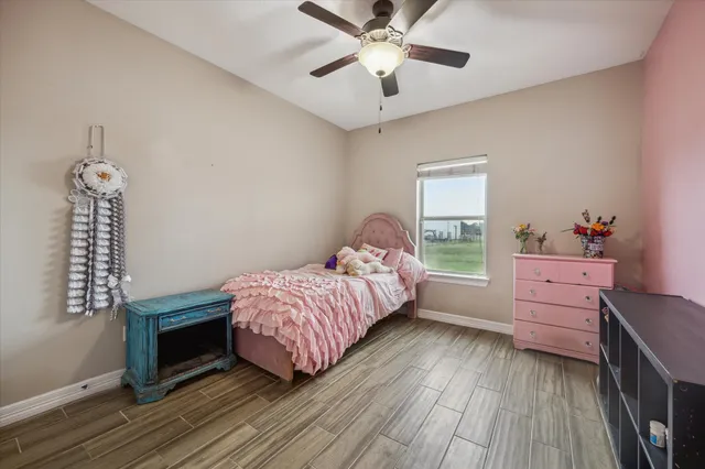 a bedroom with a bed dresser and a window
