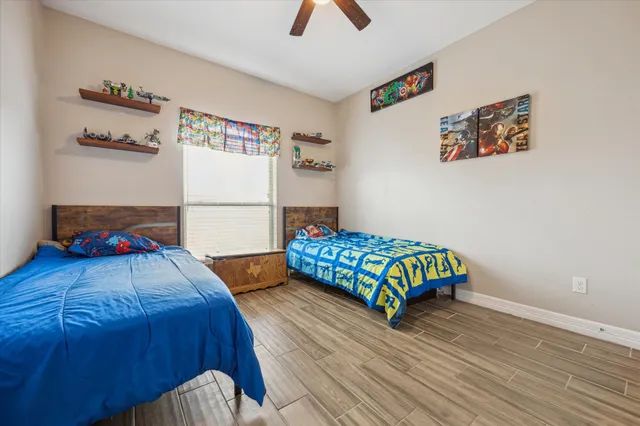 a bedroom with a bed and painting on the wall