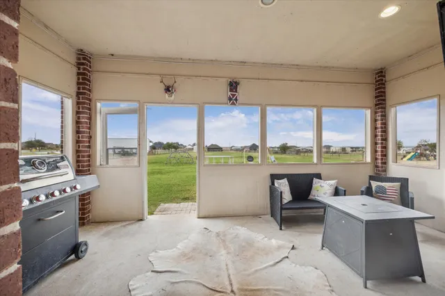 a kitchen with a large window and a view of living room