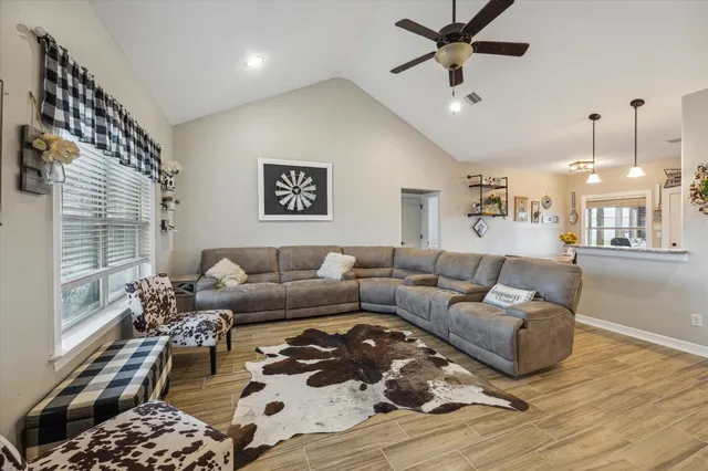 a living room with furniture and a chandelier