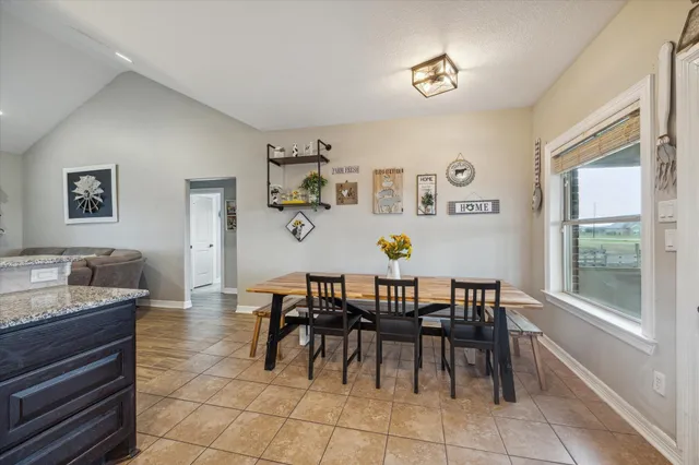 a dining room with furniture and window