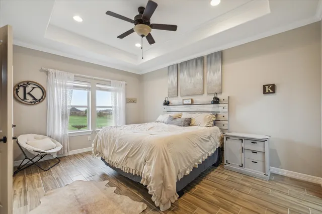 a spacious bedroom with a bed and a window