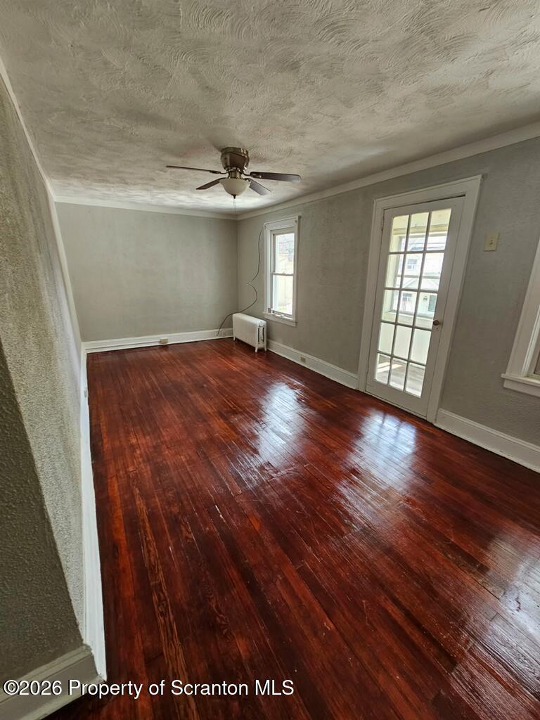 130 Willow Street Dunmore, PA 18512 - Photo 4 of 7 an empty room with wooden floor and windows