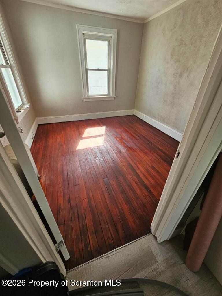 130 Willow Street Dunmore, PA 18512 - Photo 5 of 7 a view of an empty room with wooden floor and a window