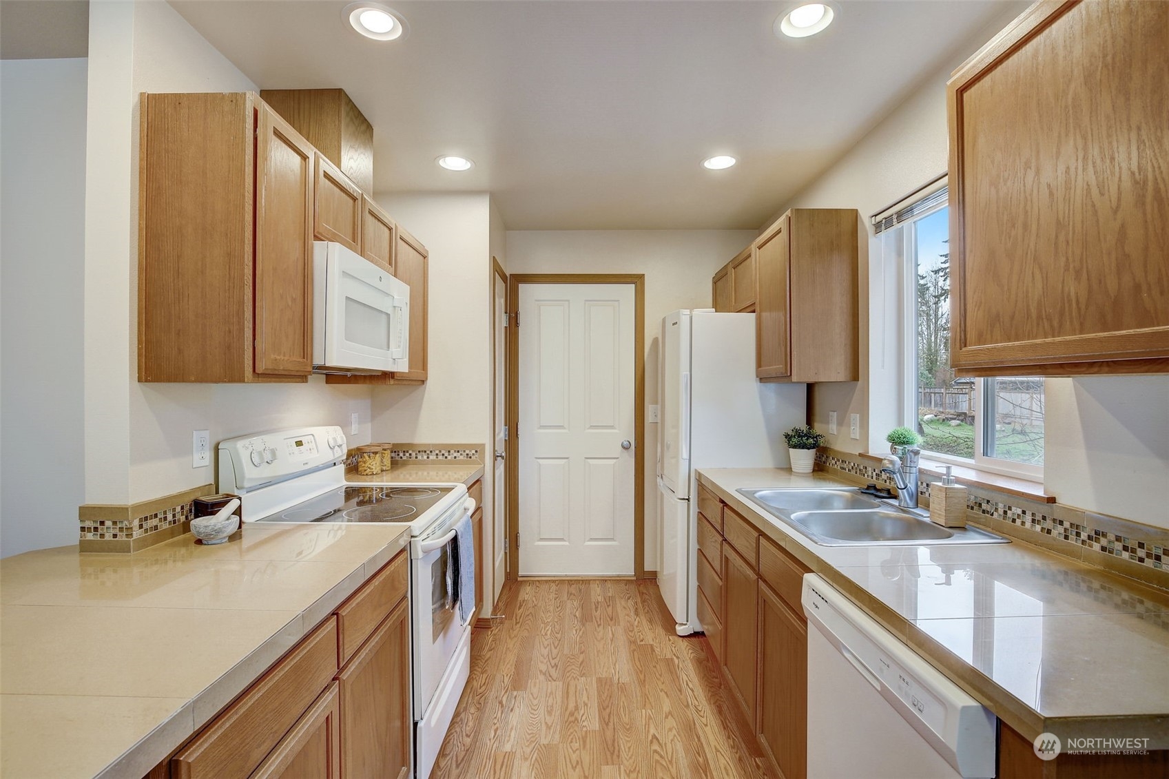 13413 Meadow Road Everett, WA 98208 - Photo 13 of 27 a kitchen with a sink stove and cabinets
