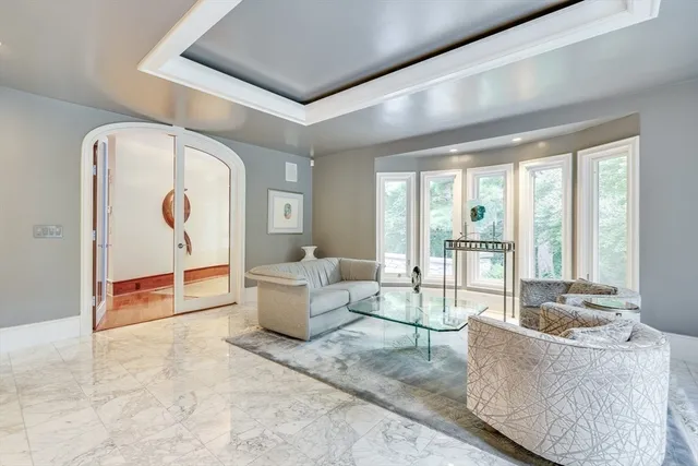 a living room with furniture and large windows