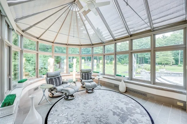 a living room with furniture and floor to ceiling windows