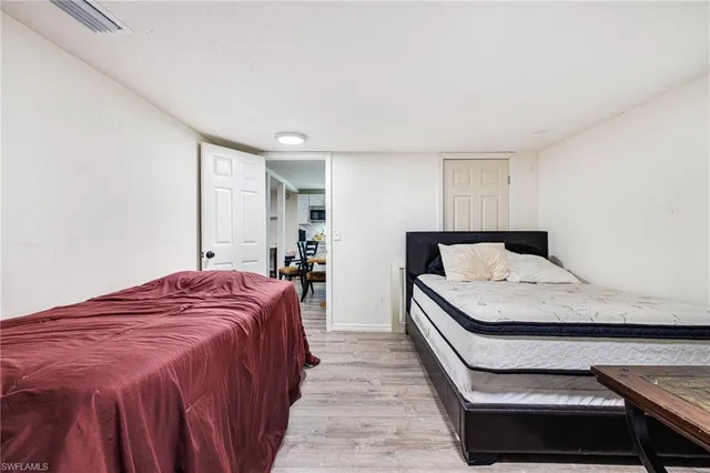 a bedroom with a bed and a night stand