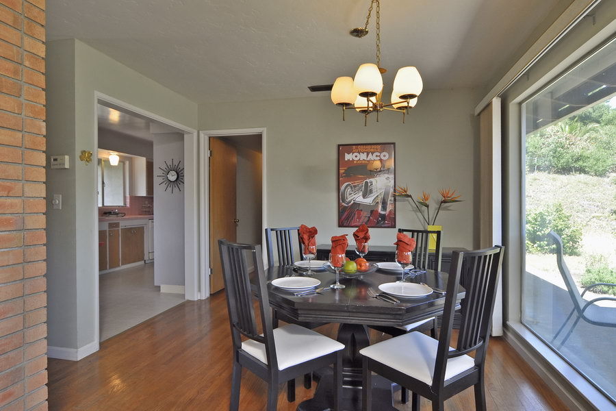 696 Cowles Road Santa Barbara, CA 93108 - Photo 5 of 14 a dining room with wooden floor a chandelier a wooden table and chairs