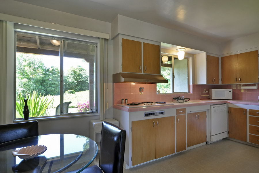696 Cowles Road Santa Barbara, CA 93108 - Photo 6 of 14 a kitchen with a stove a sink and wooden cabinets