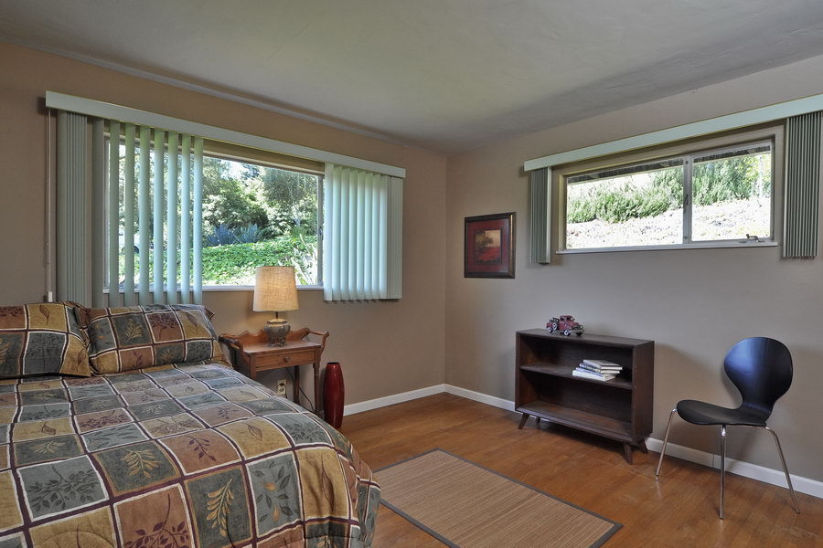 696 Cowles Road Santa Barbara, CA 93108 - Photo 10 of 14 a bedroom with a bed a desk and chair with window
