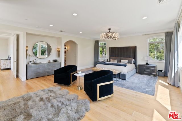 a bedroom with a bed and a mirror