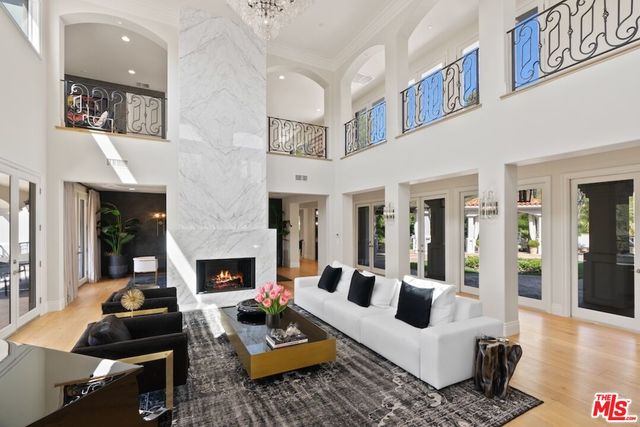 a dining room with furniture a chandelier and wooden floor