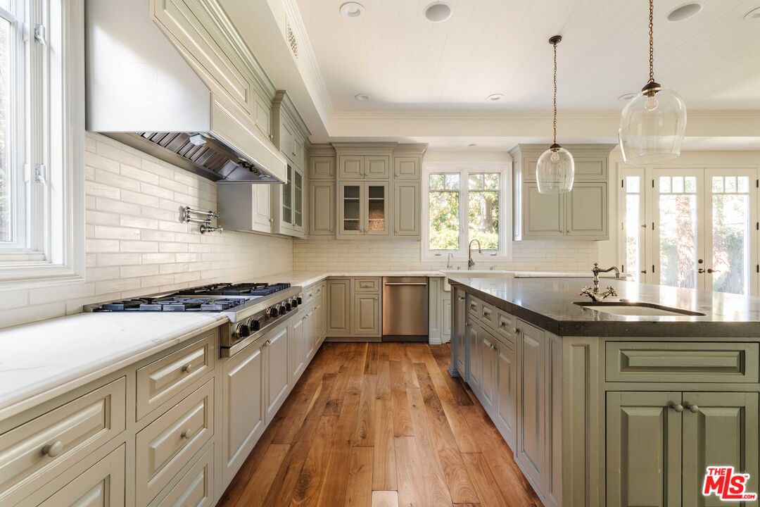 685 San Lorenzo Street Santa Monica, CA 90402 - Photo 11 of 44 a kitchen with stainless steel appliances granite countertop a stove and a sink