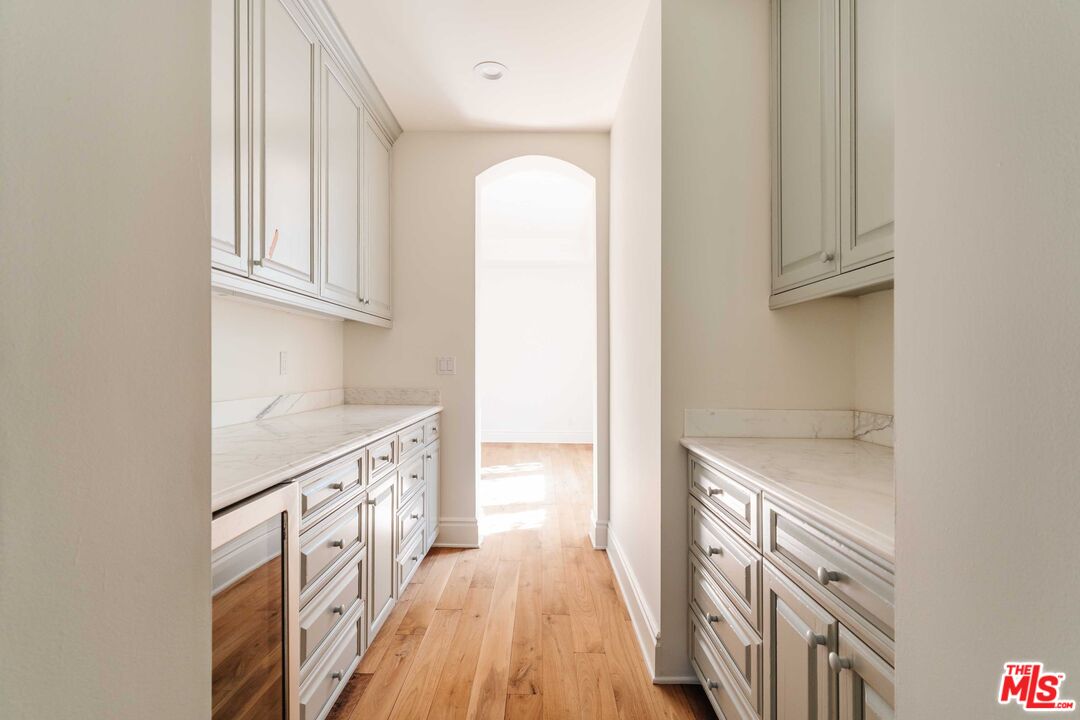 685 San Lorenzo Street Santa Monica, CA 90402 - Photo 13 of 44 a kitchen with granite countertop a sink stainless steel appliances and cabinets
